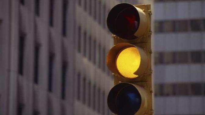 What do you do when you see a yellow traffic light?