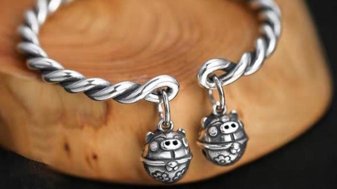 How do I make these 2 bells of my bangle less noisy?