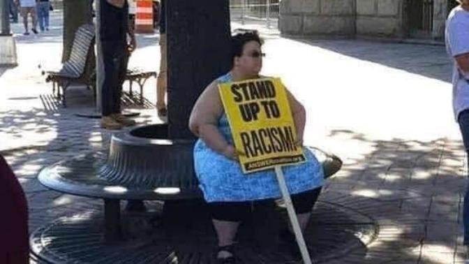 What does this protester want us to do?