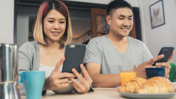 Who spends more time on the phone: men or women?