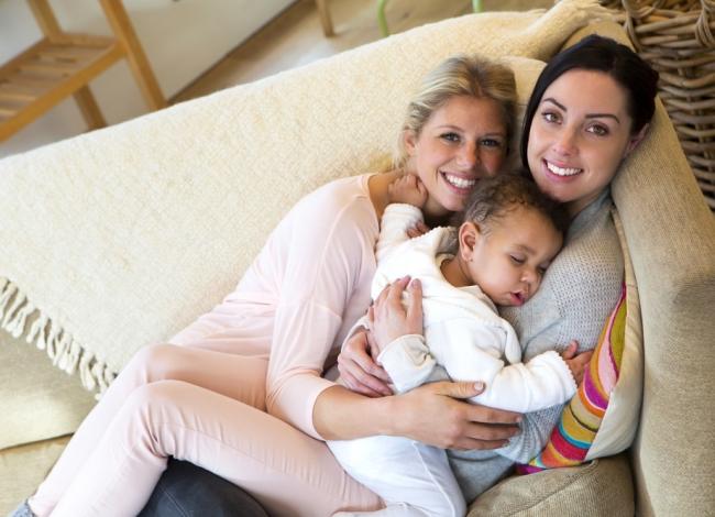 How do lesbians decide who will have the child when they want a baby through Artificial Insemination?