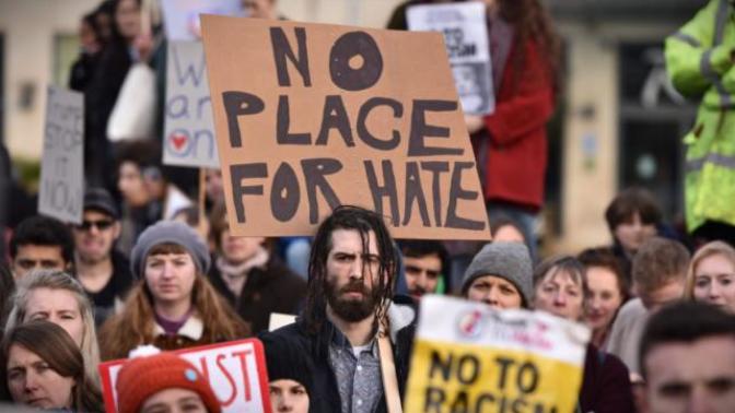 This image probably looks similar to you, anyways, what kind of personality you think the man in the middle holding the sign has?