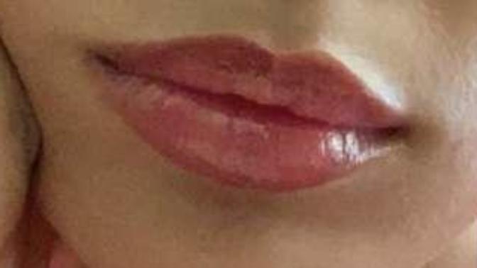 If a girl where's lip gloss like this is she still considered natural?