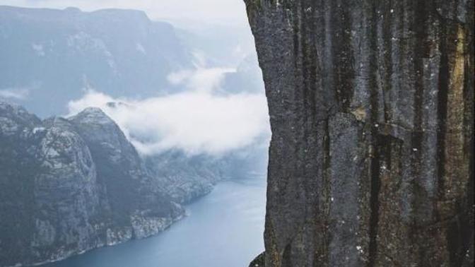 Would you like to stand atop Preikestolen and see the view of Lysefjorden in Norway?