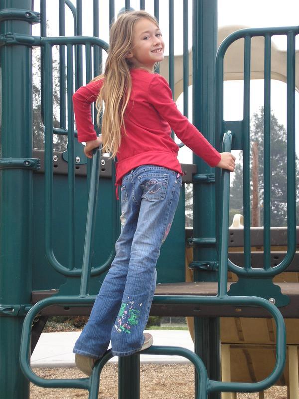 Do you think this girl with a design on her bottom right pants leg is fashionable and what design is it?