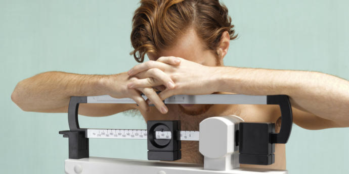 Why are eating disorders in men commonly overlooked?