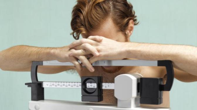Why are eating disorders in men commonly overlooked?