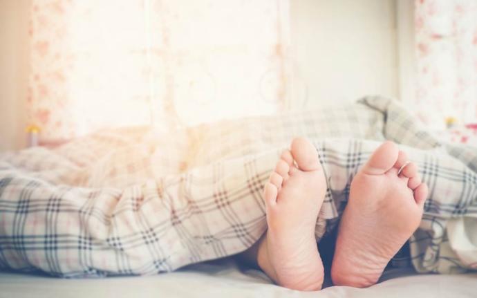 When you sleep, do you tuck the blankets underneath your feet, let the blanket hang over the bed, or keep your feet sticking out?