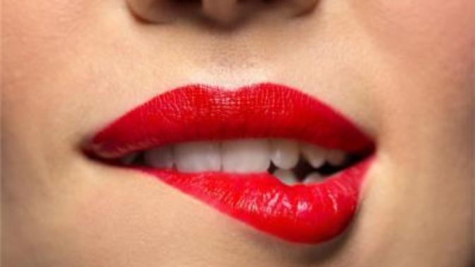 Why girls bite lips lower lip?