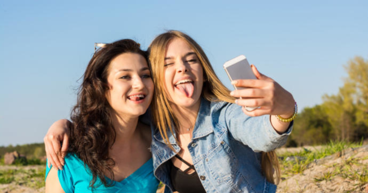 Why do GIRLS stick out their tongues in a picture?