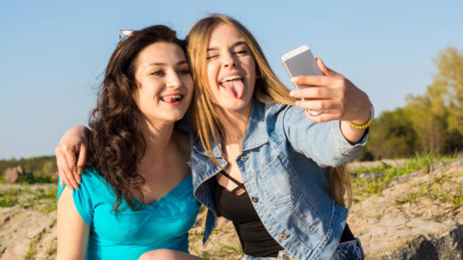 Why do GIRLS stick out their tongues in pictures on Facebook?