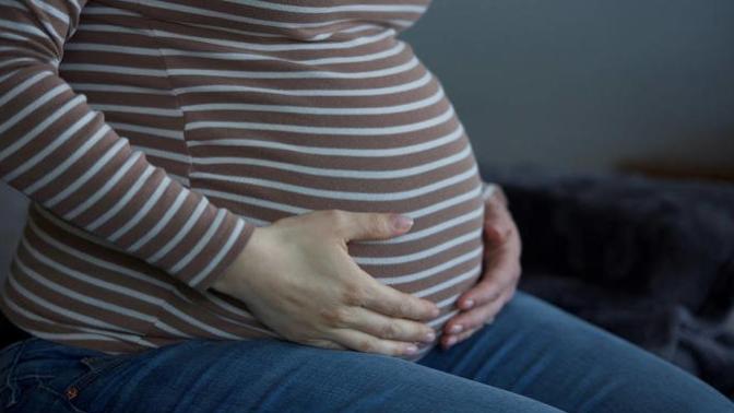 My sister is pregnant, and she's due near my wedding date. Should I ask her not to go?