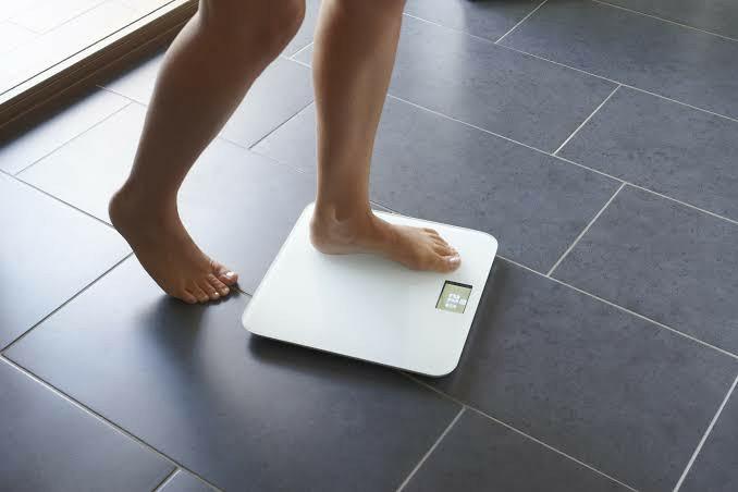 Should I check my weight daily or weekly?