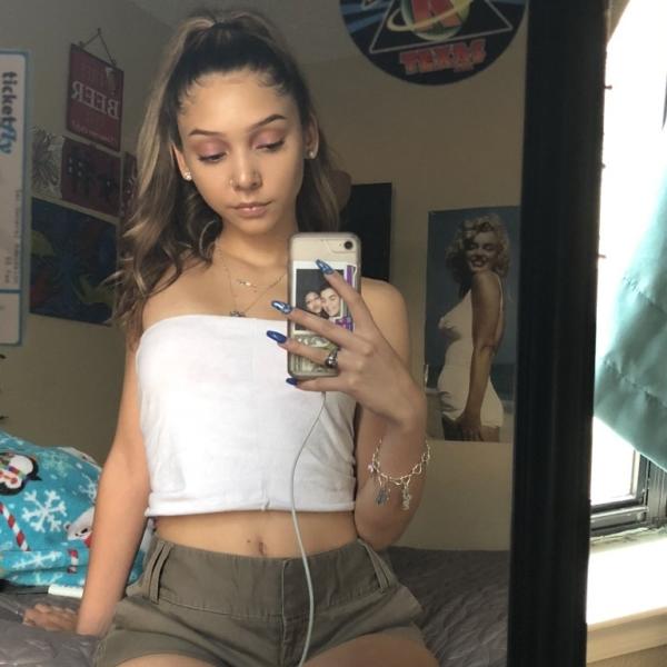 Which of these tops that this woman is wearing is of a better color?