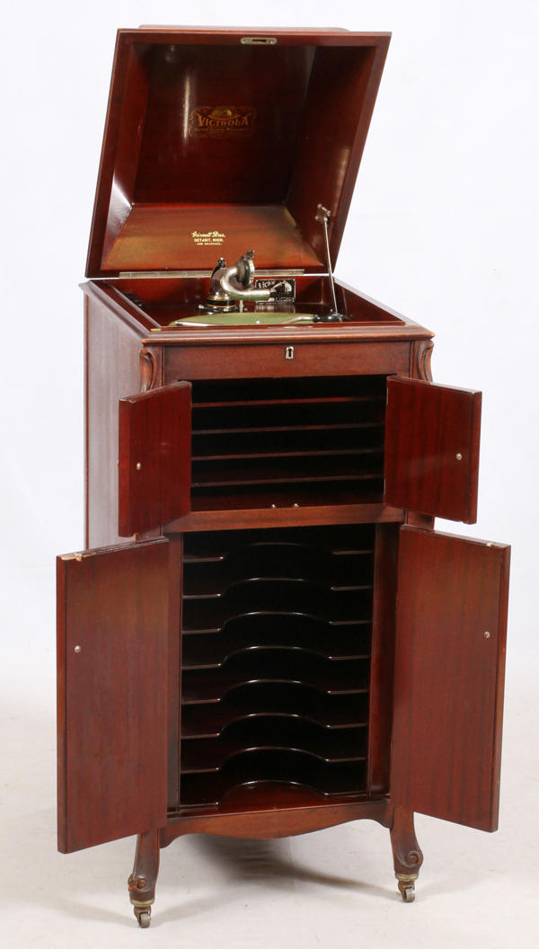 .1906 Victor Victrola (the middle shelf is actually a wooden speaker and not a shelf) You hand crank it to play records. 