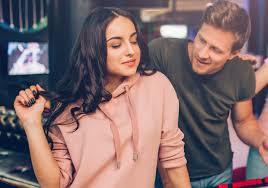 What does it mean when a girl plays with her hair while she is talking to you?