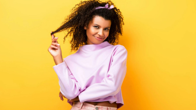 What does it mean when a girl plays with her hair while she is talking to you?