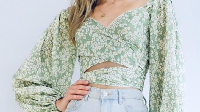 Which shirt do you like better with mid rise flare jeans ( not the ones she’s wearing) and black boots?
