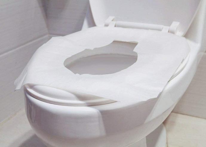 Should you use toilet seat covers while pooping in public restrooms?