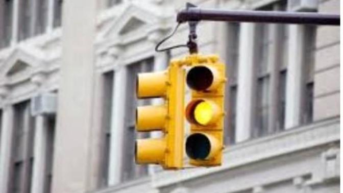 What do YOU do at the light as it's turning yellow: go through, slow down, or stop?