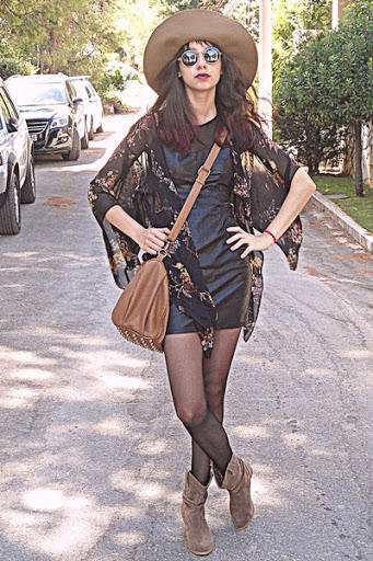 Which woman rock the leather dress and boots style the most?