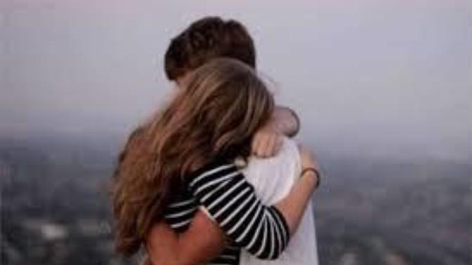 What should be the proper reaction for a guy when a girl who is not his girlfriend is crying in his arms?