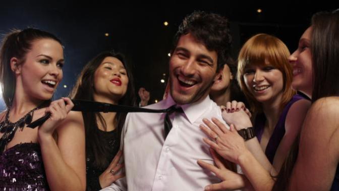 Why are women more attracted to men who are surrounded my many females than man who are not?