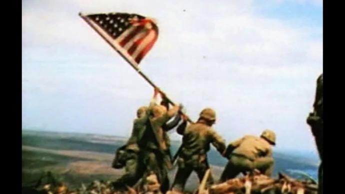 Marines keep American Flag from falling on ground risking sniper fire.