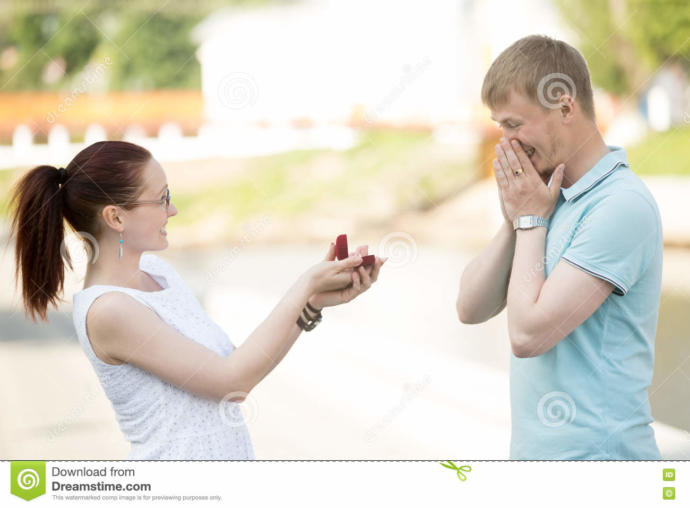 (Woman showing ring to man)