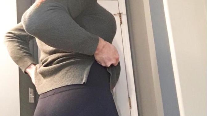 Which of these women seems to be wearing the most comfortable clothing style?