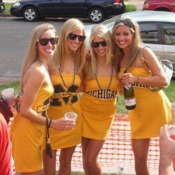 Which quartet (group of 4) of Michigan State Spartans versus Michigan Wolverines women has the better outfits?