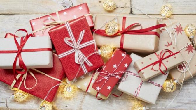 Should I buy my boyfriend's family Christmas gifts if I am not going to spend it with them this year?