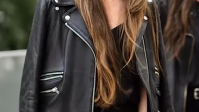 Why do girls sometimes wear jackets without their arms in the sleeves? Especially leather jackets?