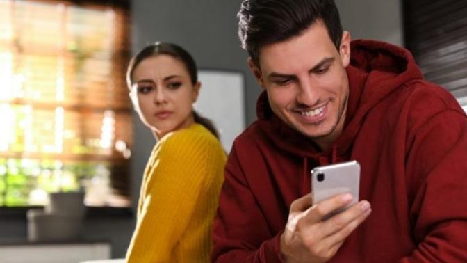Why does my guy friend hide his phone from me?