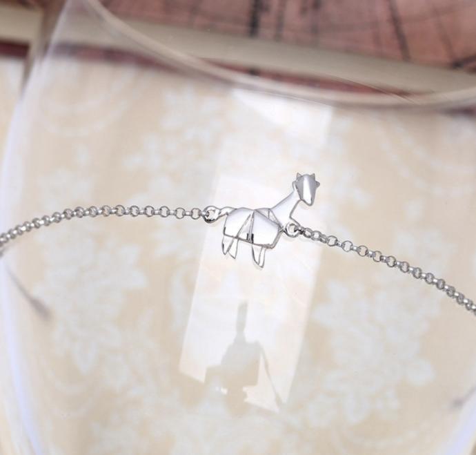 Which giraffe jewelry is cuter?