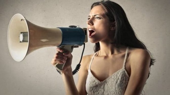 What are the reasons women try to get the attention of other women?