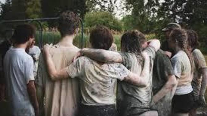 Whilst in a group photograph where should I place my hands on girls standing next to me?