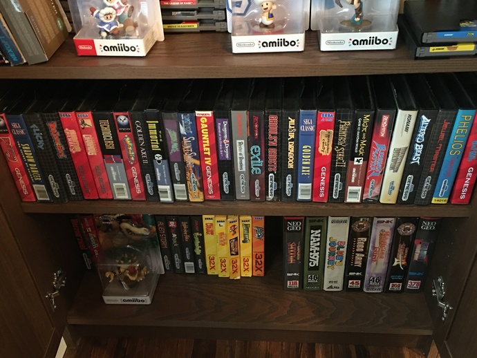 My clam shelled Sega Genesis game collection (also the neo geo and 32x games on bottom shelf)