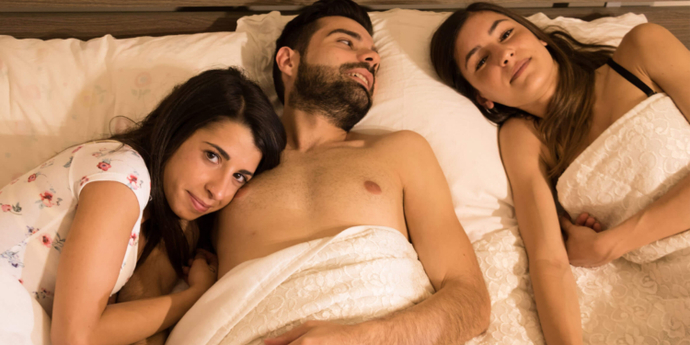 Two women in bed with man? New research indicates that most people are interested in having a threesome? It is popular in area?