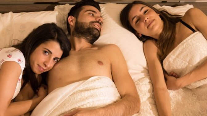 Two women in bed with man? New research indicates that most people are interested in having a threesome? It is popular in area?