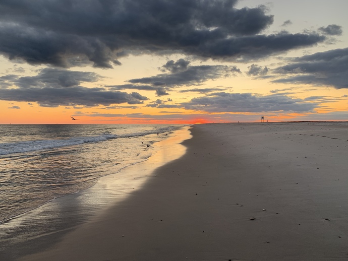 Sun set at Jones Beach just a few miles from me , usually get different colors through the clouds and water too 