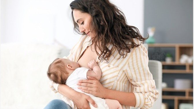 Why does society frown on women who breast feed?