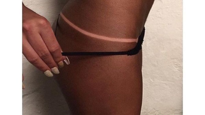 Why is dark skin considered attractive if a white person has it?