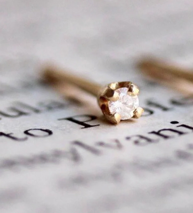 Which of these diamonds studs looks daintier for a second hole with a regular stud earring?
