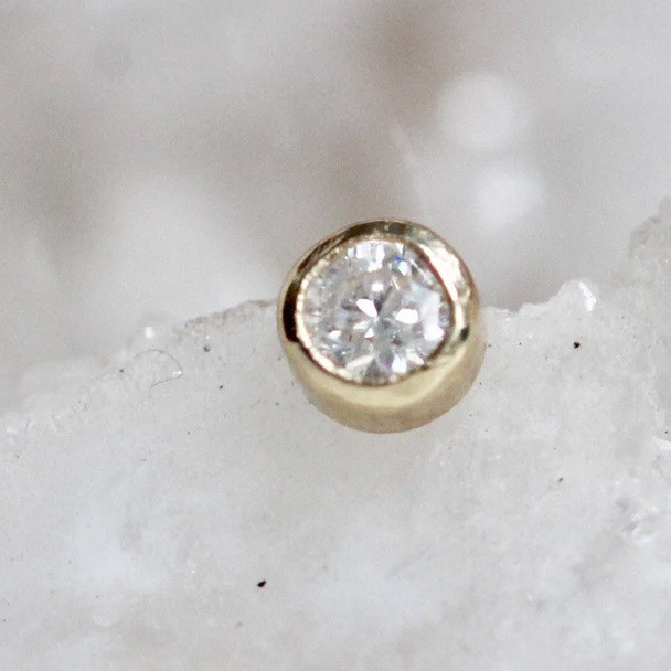 Which of these diamonds studs looks daintier for a second hole with a regular stud earring?
