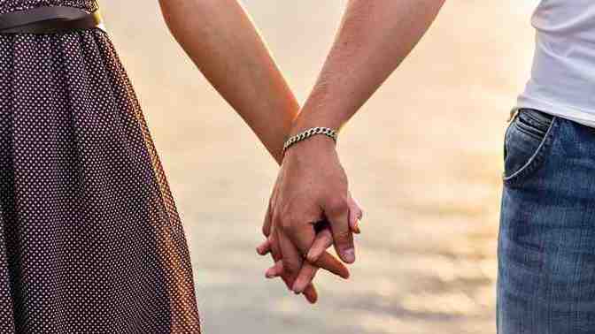 Can you explain why it is important to hold hands with your partner in public?