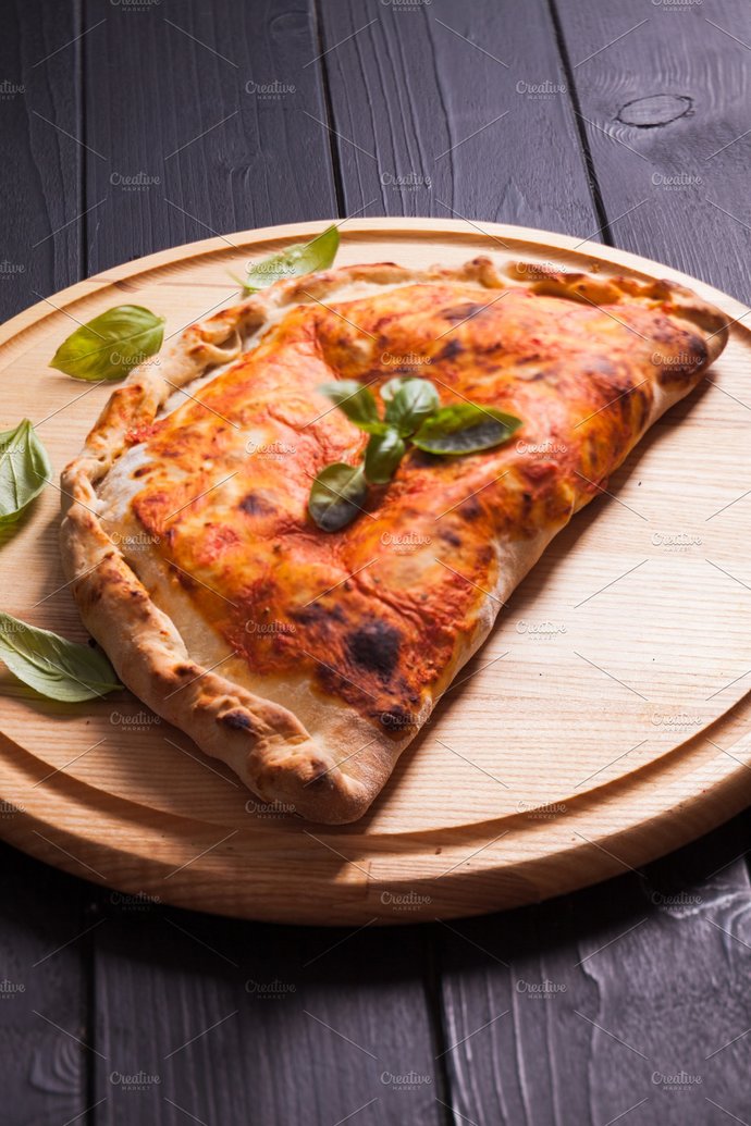Calzone means one half is lapped over and it´s baked again