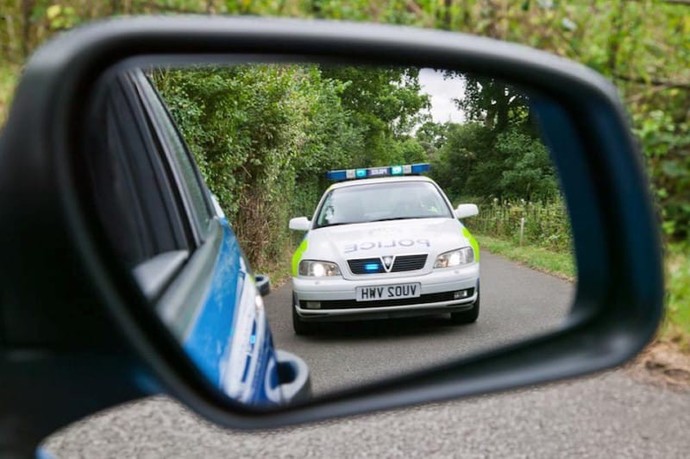 How do you feel when you see a police car in your rear view mirror?