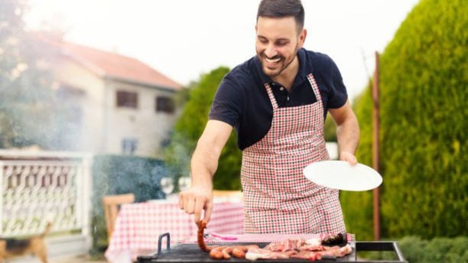 Is cooking meat on a grill a "man's job"?