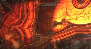 Thin slab of onyx stone, backlit. Lineal and random patterns. 